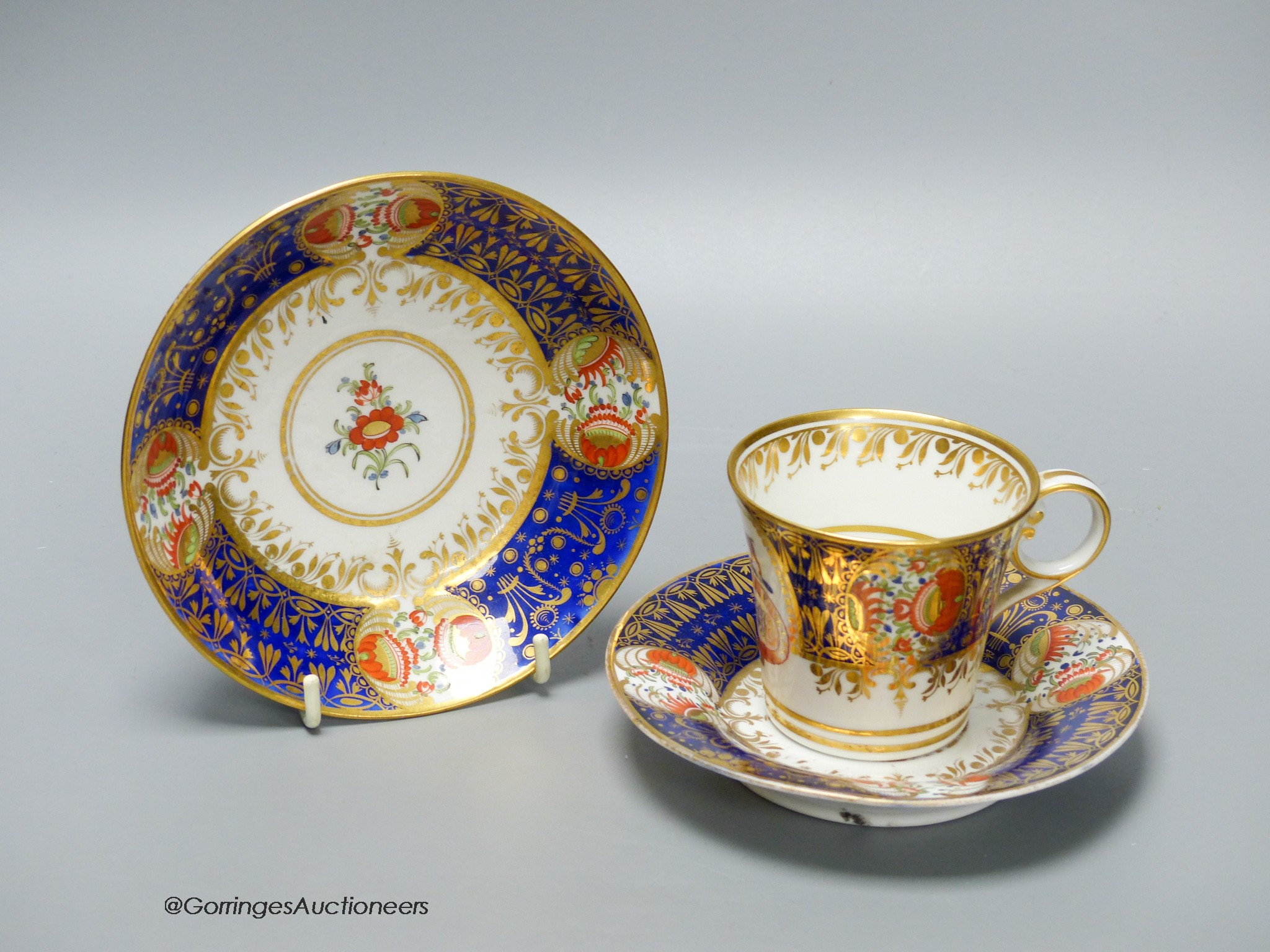 A Chamberlain armorial or crested cup and saucer in the style of the Yeo service and Chamberlain Worcester crested saucer